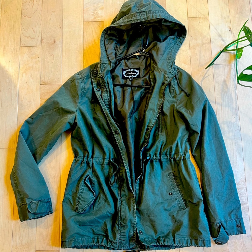 Women’s army green utility jacket. Long and falls under hips. Size large